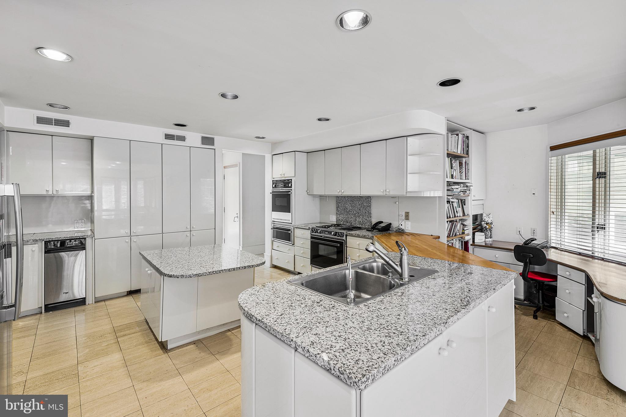 655 Matsonford Road Villanova, PA 19085 - Photo 22 of 63 a kitchen with stainless steel appliances granite countertop a sink a stove and a refrigerator