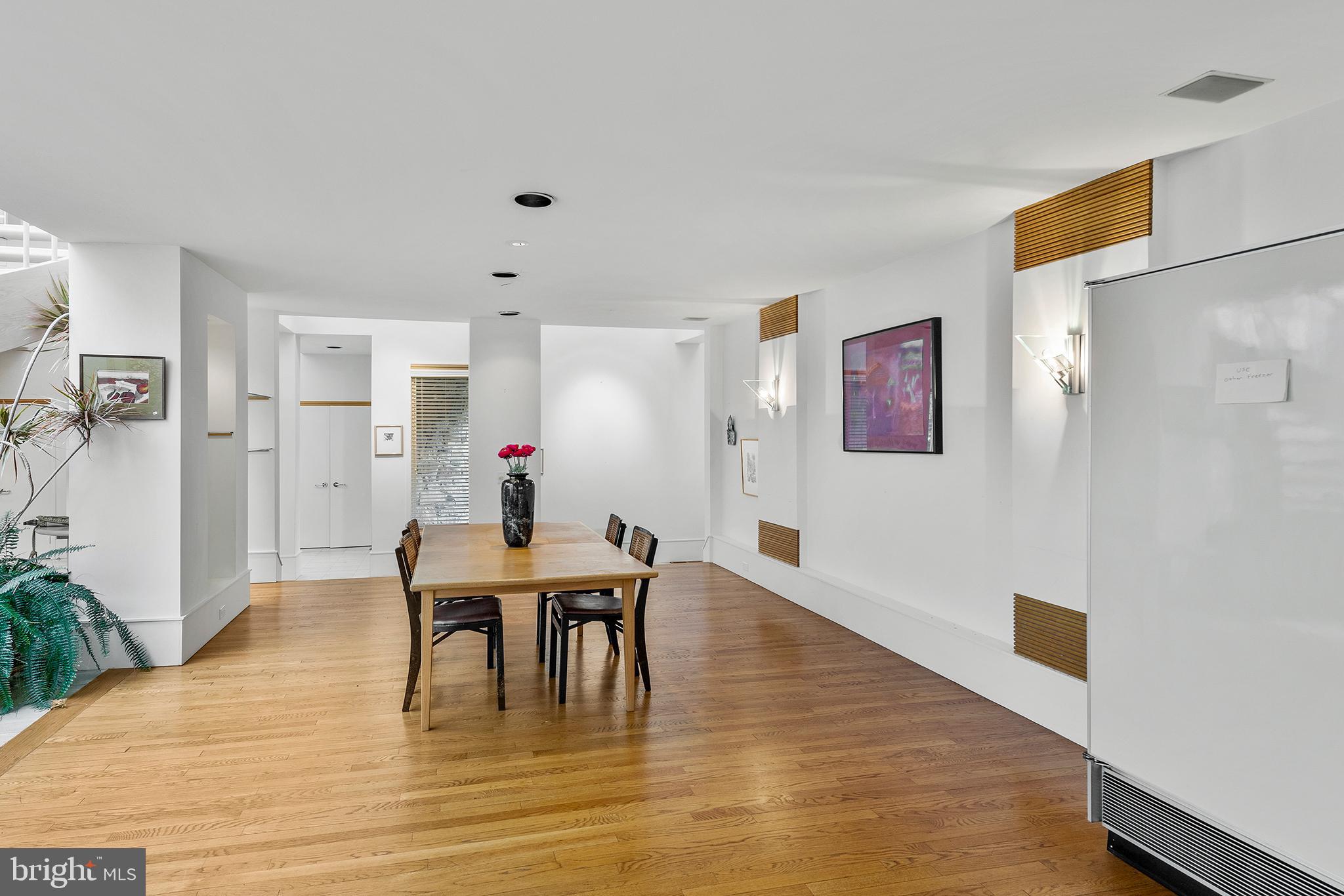 655 Matsonford Road Villanova, PA 19085 - Photo 28 of 63 a dining room with furniture potted plants and wooden floor