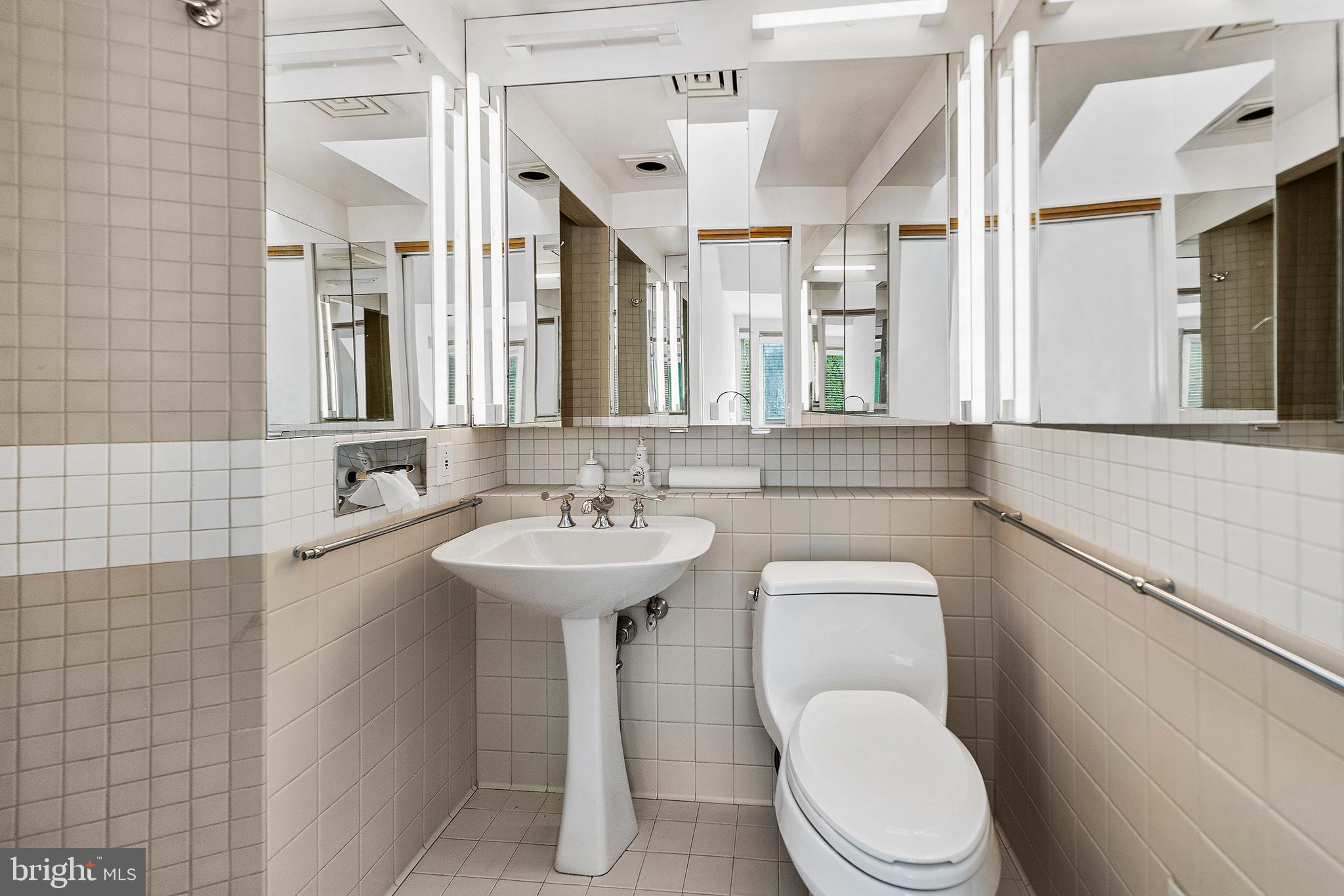 655 Matsonford Road Villanova, PA 19085 - Photo 55 of 63 a bathroom with a toilet sink and mirror