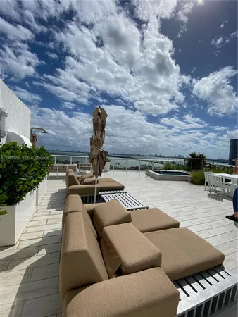 a view of a house with backyard sitting area and garden