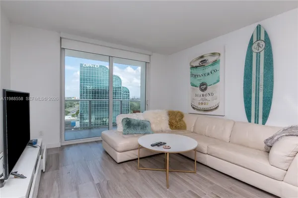 a living room with furniture and a flat screen tv