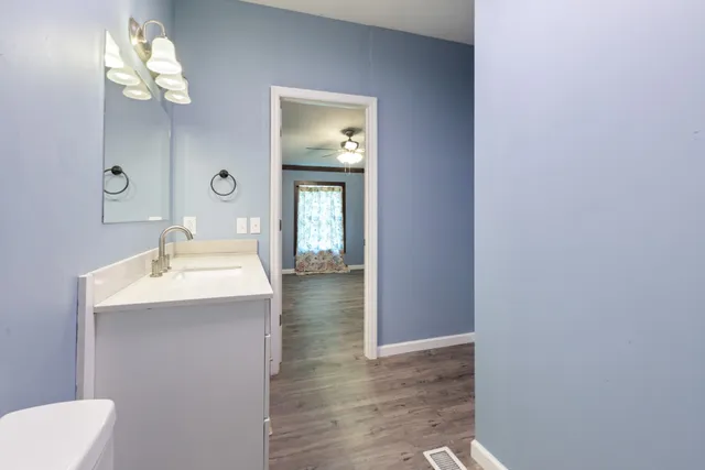a bathroom with a sink vanity and mirror