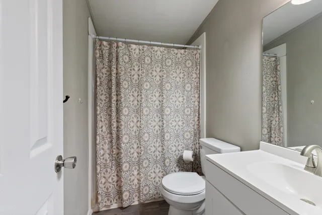 a white toilet sitting next to a bathroom sink