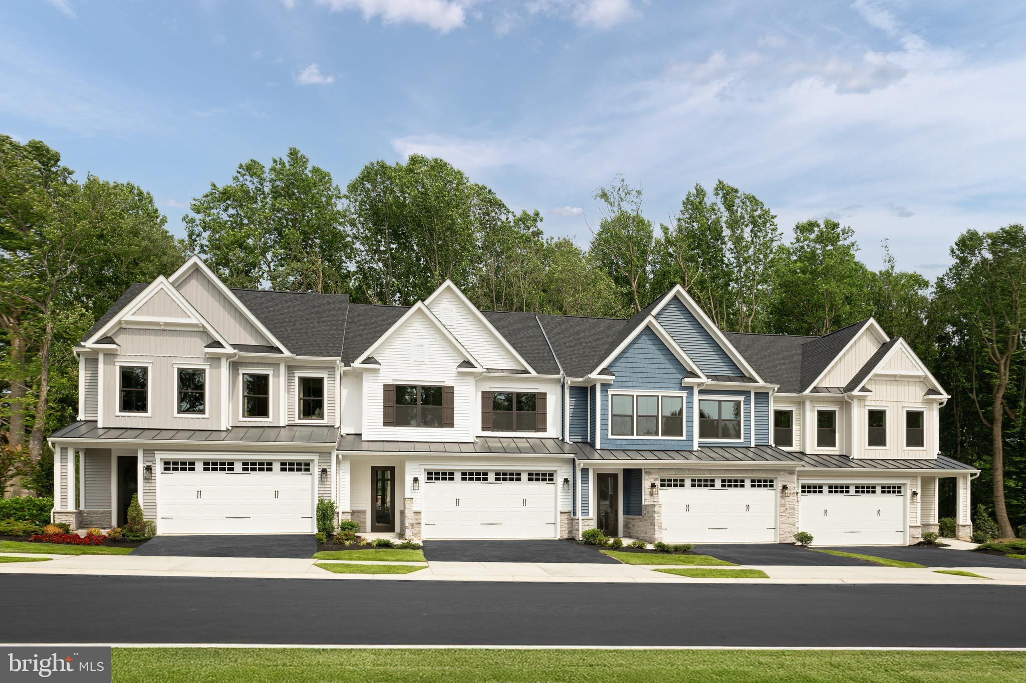 9676 Wishing Well Lane Ellicott City, MD 21042 - Photo 1 of 25 a view of a white house with a large windows and a yard with plants and large trees