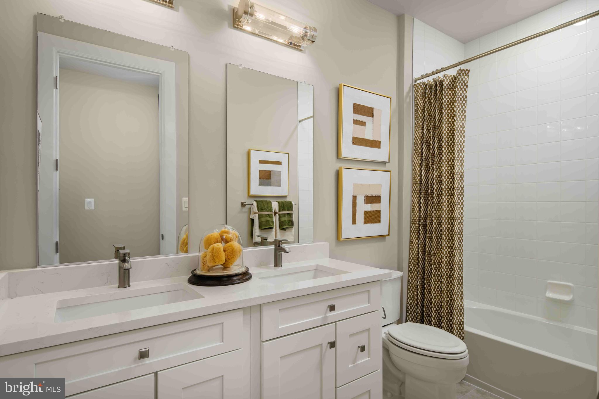 9676 Wishing Well Lane Ellicott City, MD 21042 - Photo 12 of 25 a bathroom with a double vanity sink toilet and shower
