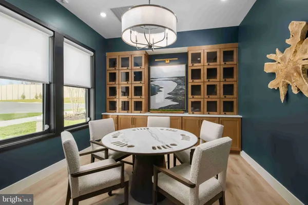 a view of a dining room with furniture and window