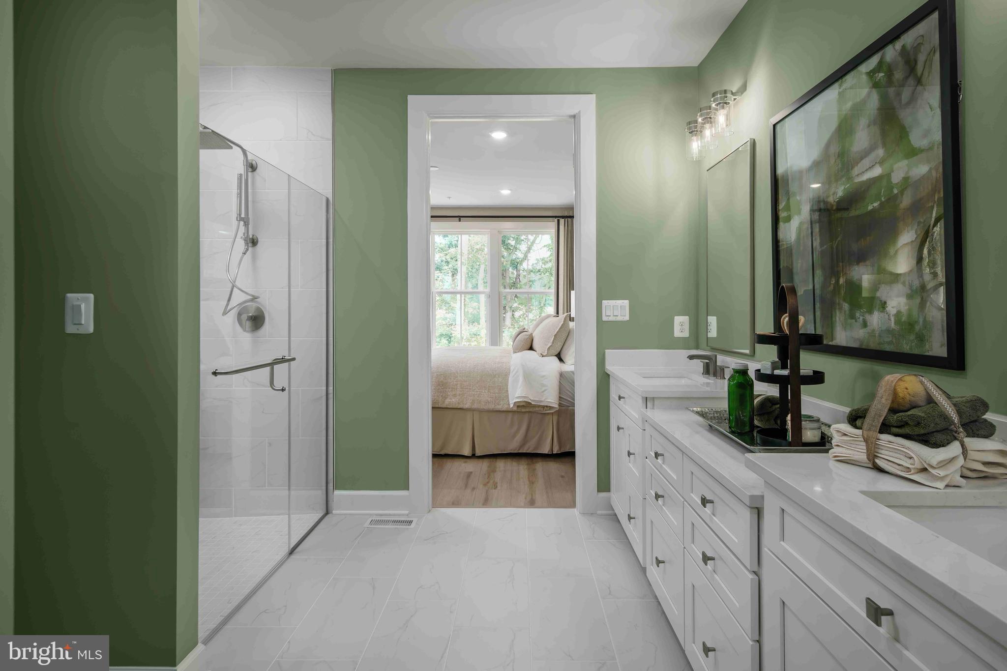 9676 Wishing Well Lane Ellicott City, MD 21042 - Photo 7 of 25 a en suite bathroom with a double vanity sink and a mirror