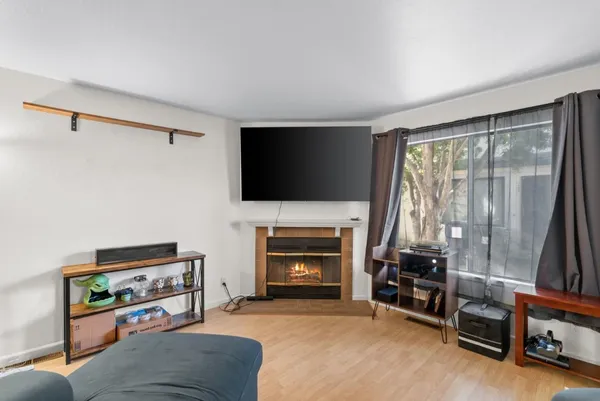 a living room with furniture a flat screen tv and a fireplace