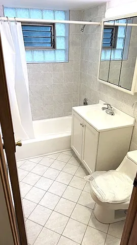a bathroom with a bathtub and shower