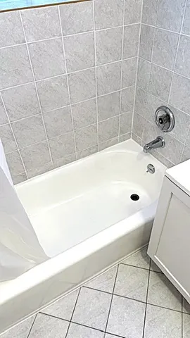 a bathroom with a bathtub and shower