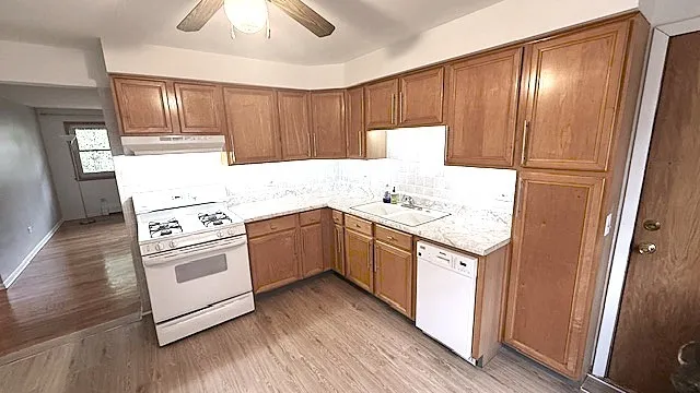 a kitchen with a white cabinets and white appliances