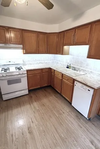 a kitchen with granite countertop a sink and a stove