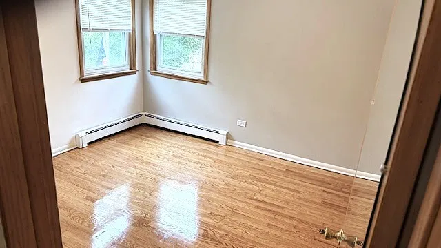 a view of a room with wooden floor and windows