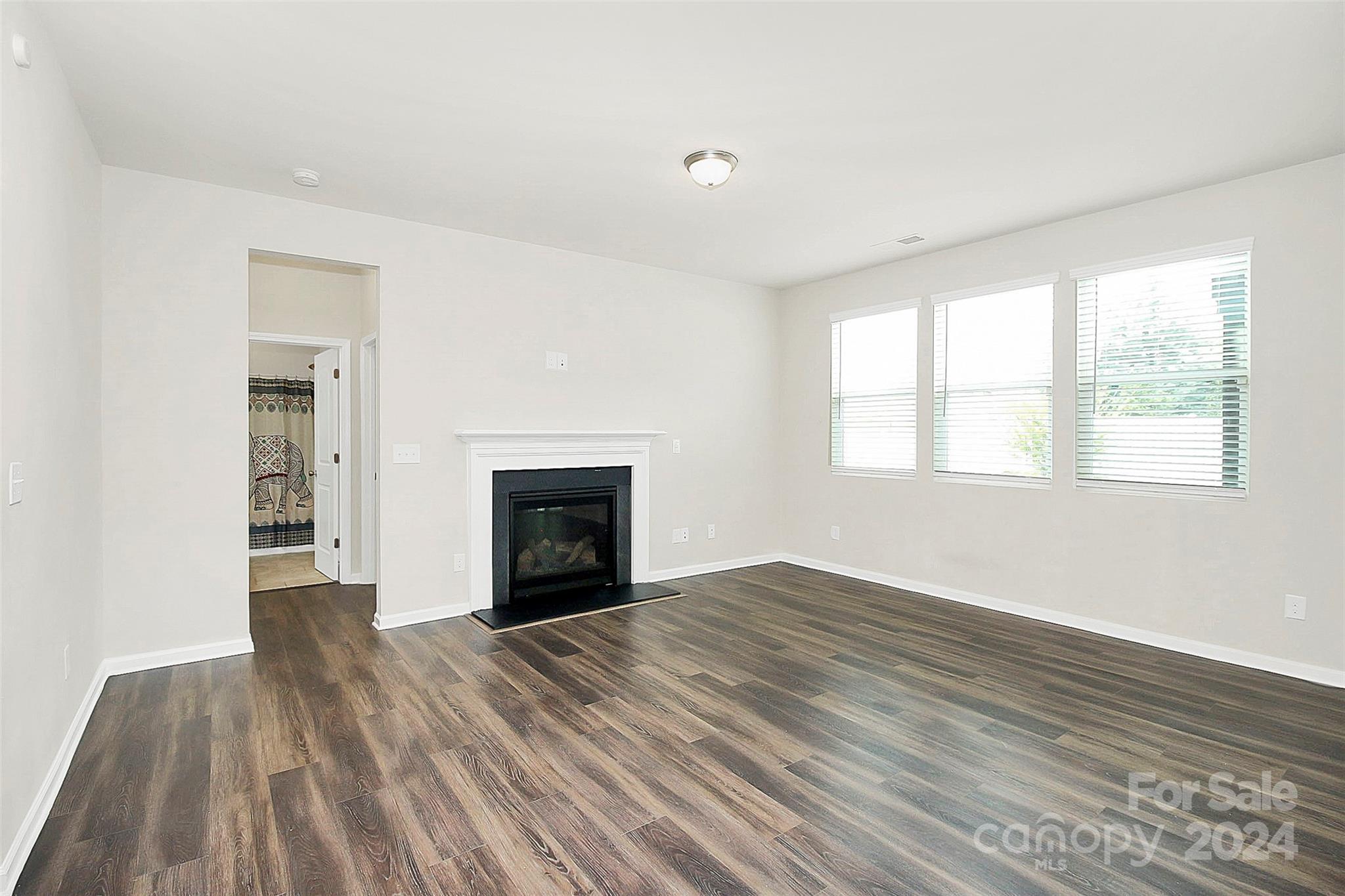 1769 Bailey Ridge Drive York, SC 29745 - Photo 4 of 47 wooden floor fireplace and windows in an empty room