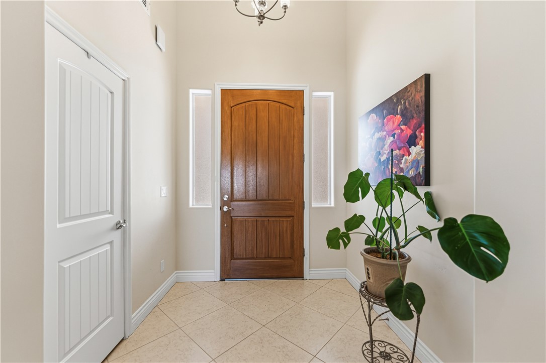 3315 Rainbow Mine Road Kingman, AZ 86401 - Photo 5 of 54 Welcoming entryway featuring a wood front door, light-toned walls, and diamond-patterned tiled flooring