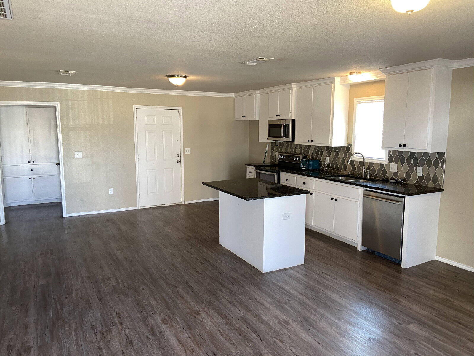 2709 Cornell Street Lubbock, TX 79415 - Photo 16 of 28 a kitchen with granite countertop a sink and cabinets