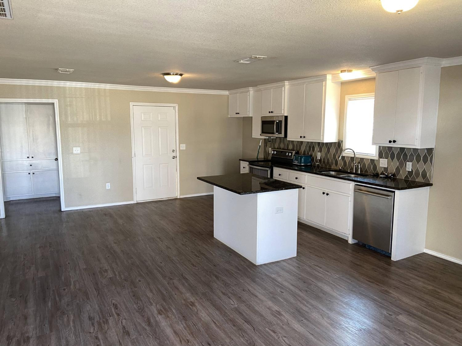 2709 Cornell Street Lubbock, TX 79415 - Photo 2 of 28 a kitchen with granite countertop a sink and cabinets