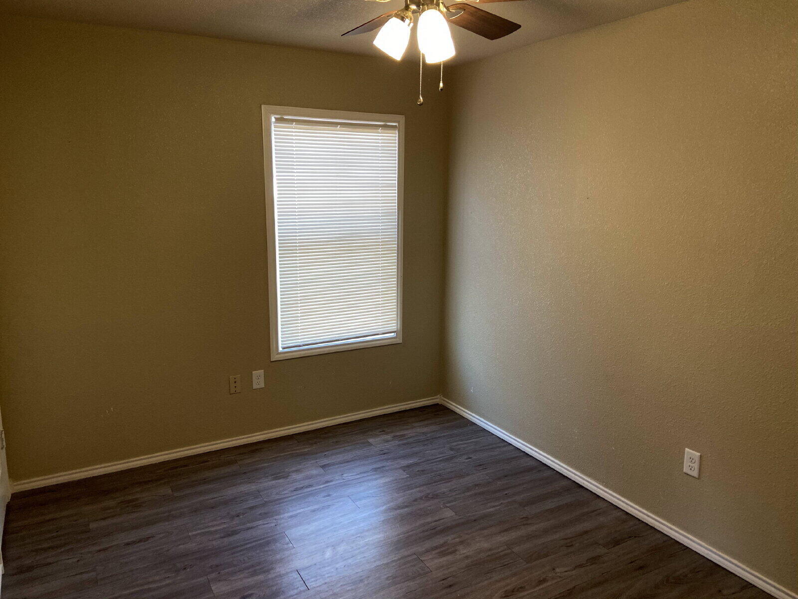 2709 Cornell Street Lubbock, TX 79415 - Photo 24 of 28 an empty room with wooden floor and windows
