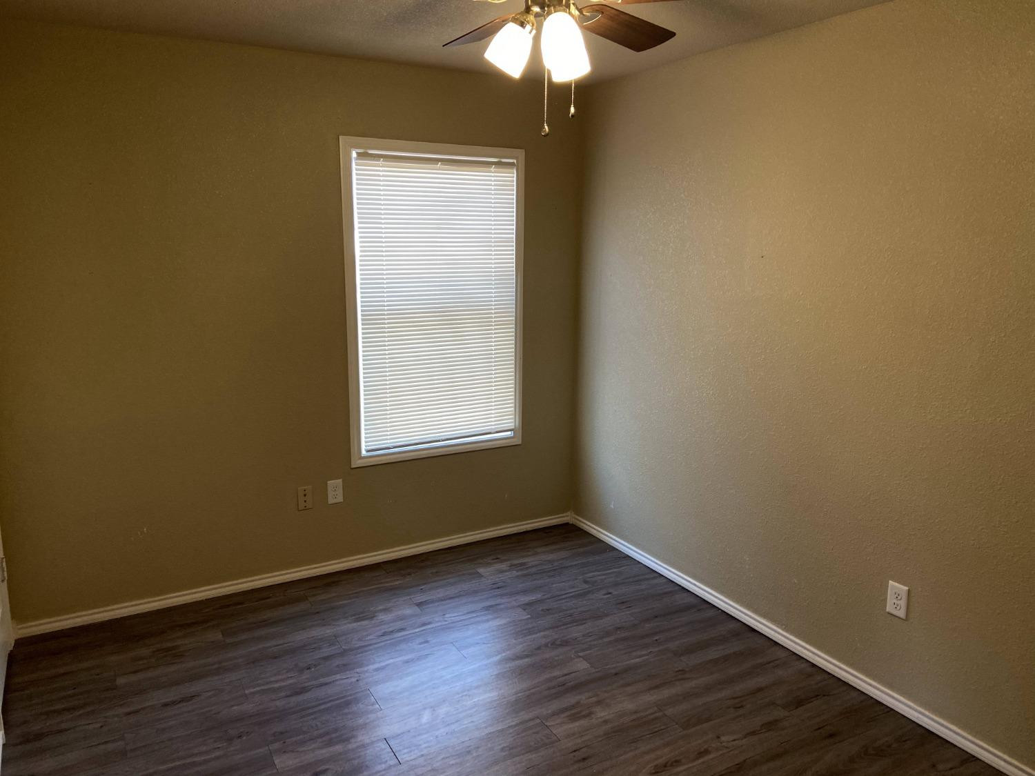 2709 Cornell Street Lubbock, TX 79415 - Photo 6 of 28 an empty room with wooden floor and windows