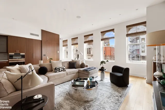 a living room with furniture window and a flat screen tv