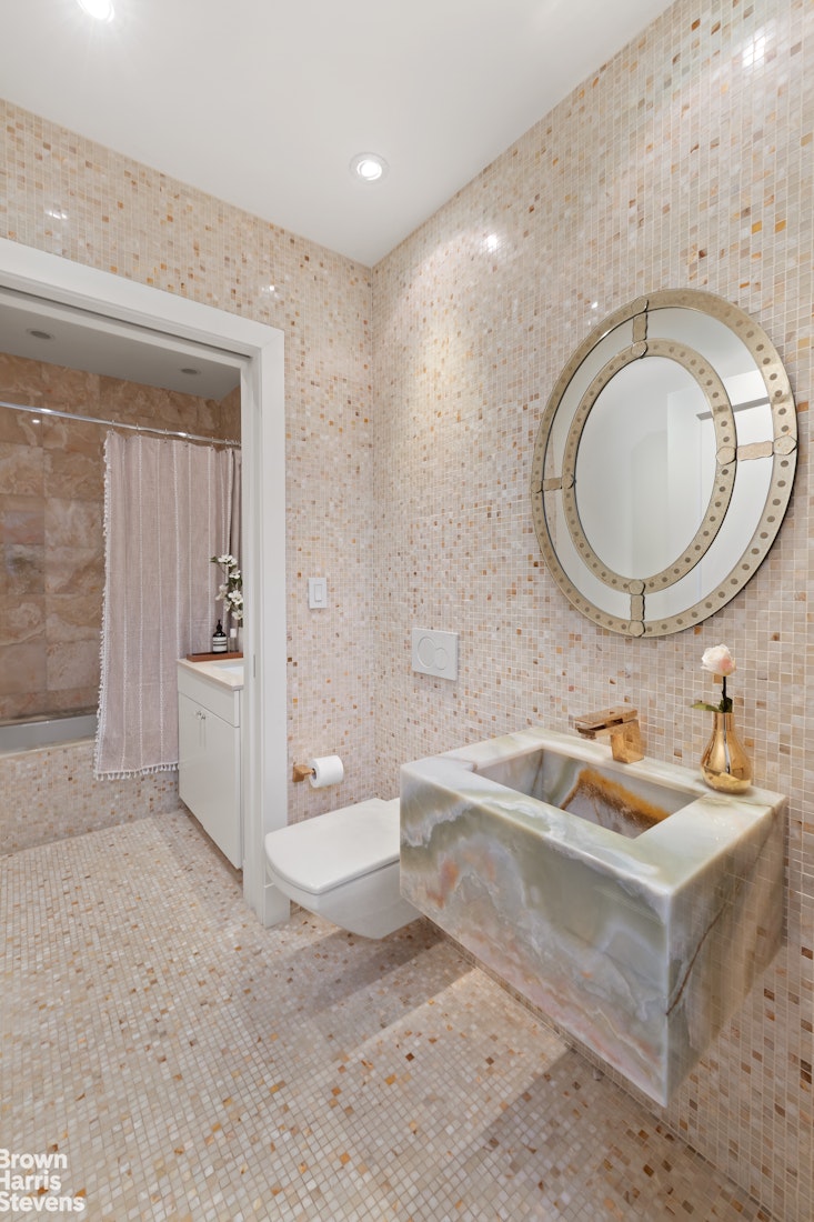 7 East 17th Street, Unit PHS Manhattan, NY 10003 - Photo 12 of 26 a bathroom with a sink a toilet and shower