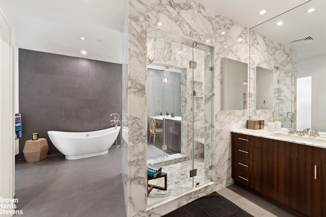 7 East 17th Street, Unit PHS Manhattan, NY 10003 - Photo 16 of 26 a spacious bathroom with a double vanity sink a mirror and a bathtub