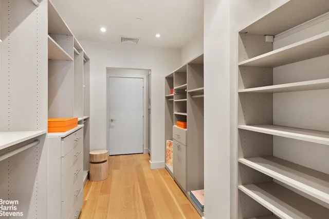a spacious bathroom with a double vanity sink a mirror and a bathtub