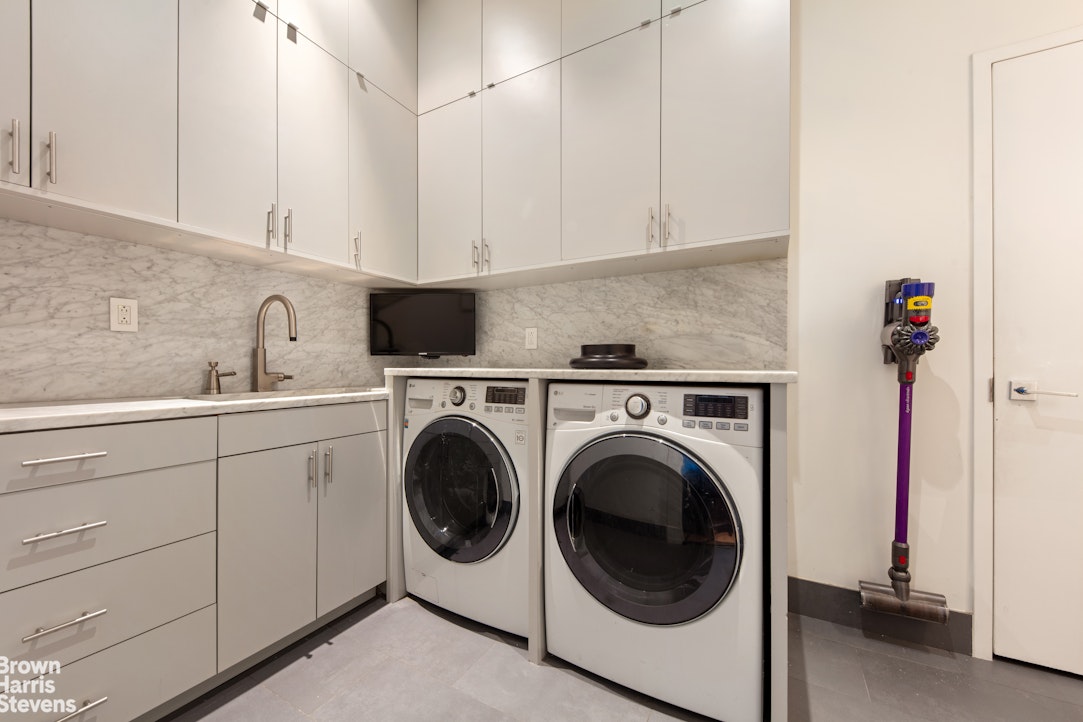 7 East 17th Street, Unit PHS Manhattan, NY 10003 - Photo 25 of 26 a utility room with sink dryer and washer