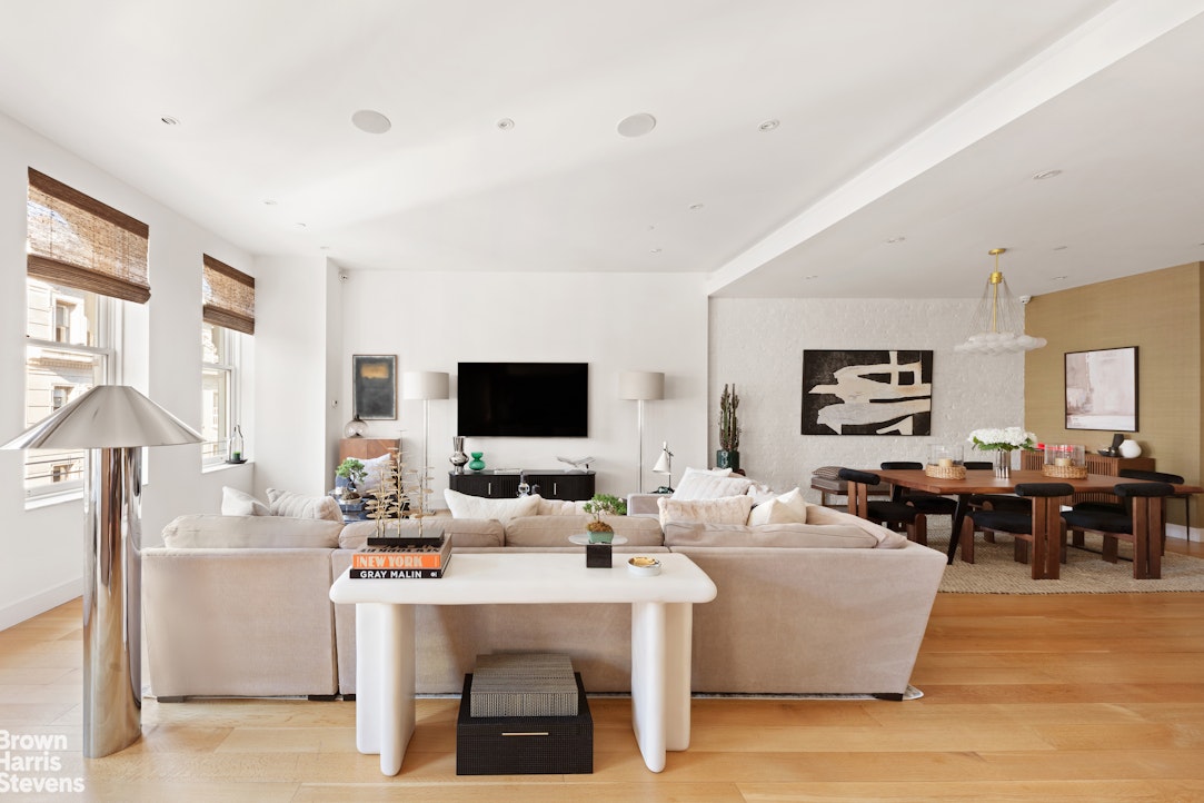 7 East 17th Street, Unit PHS Manhattan, NY 10003 - Photo 2 of 26 a living room with furniture a flat screen tv and kitchen view