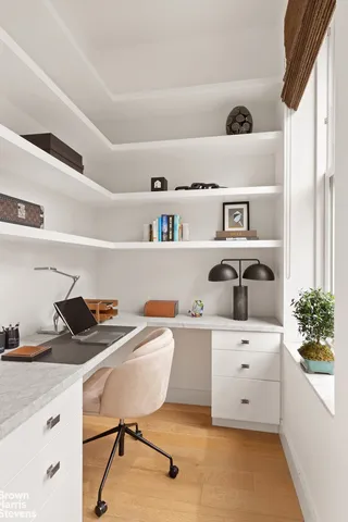 a living room with furniture a flat screen tv and kitchen view