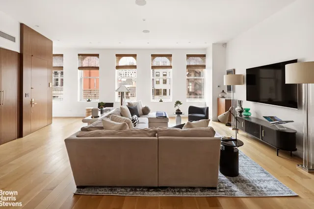 a living room with furniture fireplace and a flat screen tv