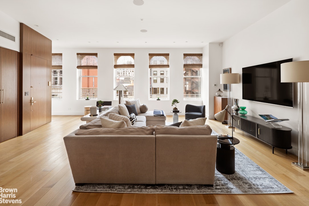 7 East 17th Street, Unit PHS Manhattan, NY 10003 - Photo 6 of 26 a living room with furniture and a flat screen tv