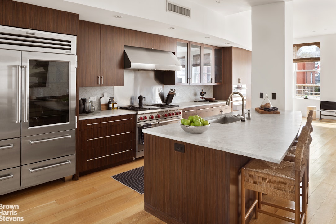 7 East 17th Street, Unit PHS Manhattan, NY 10003 - Photo 7 of 26 a kitchen with a sink a stove and cabinets