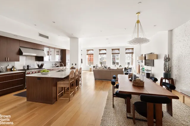 a kitchen with a sink a stove and cabinets