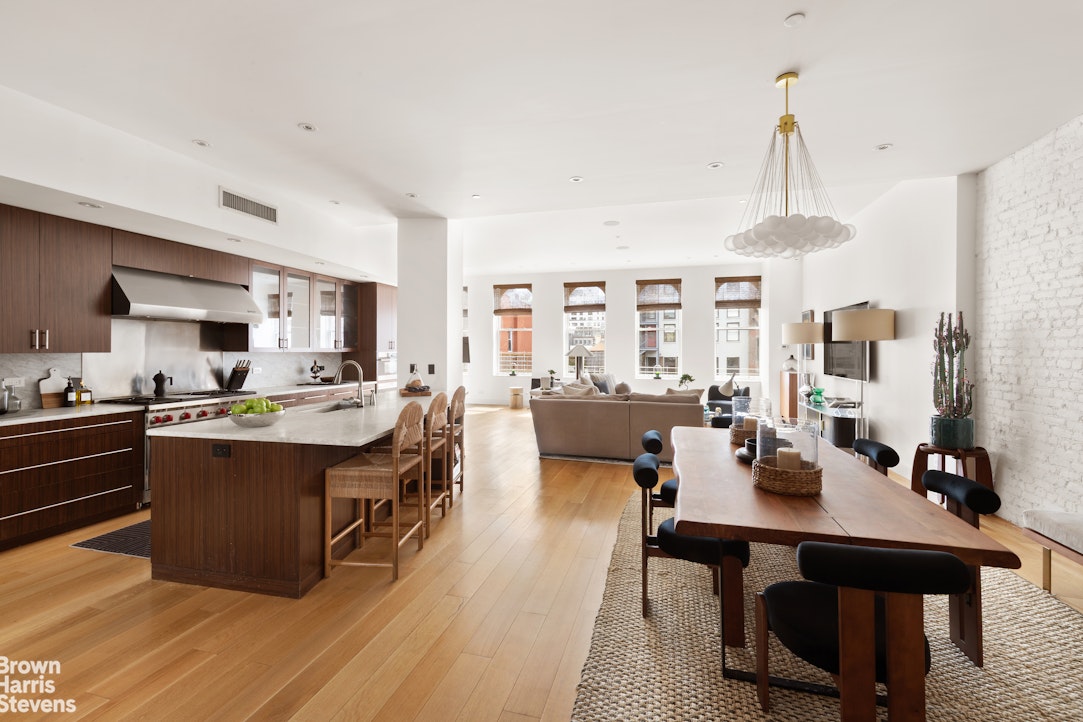 7 East 17th Street, Unit PHS Manhattan, NY 10003 - Photo 8 of 26 a living room with stainless steel appliances kitchen island granite countertop furniture and a kitchen view