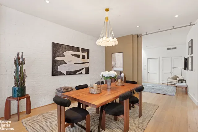 a living room with stainless steel appliances kitchen island granite countertop furniture and a kitchen view