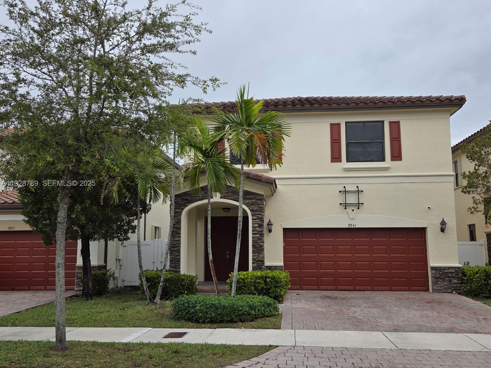 8841 West 34th Court Hialeah, FL 33018 - Photo 1 of 48 a front view of a house with a yard and garage