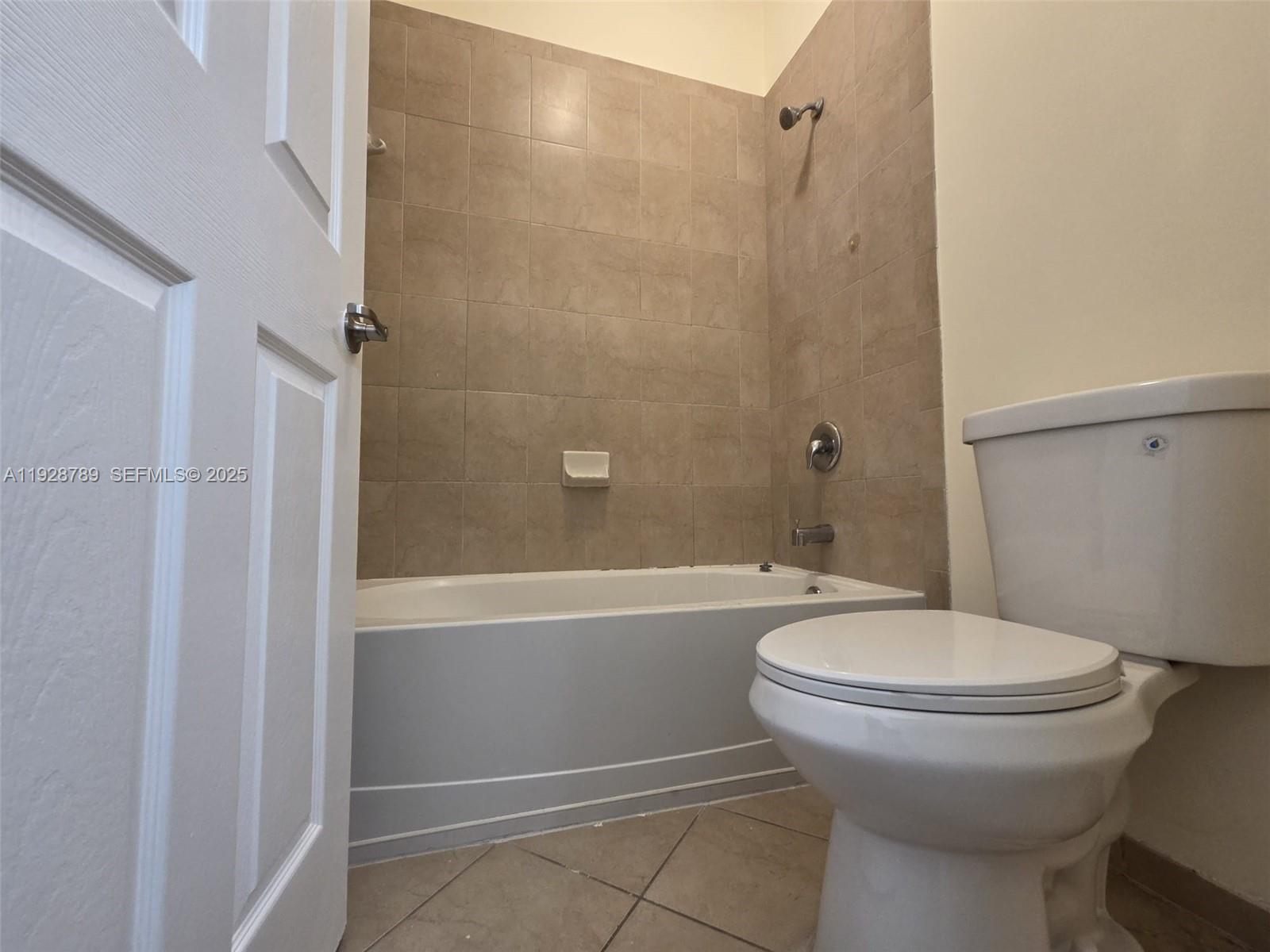 8841 West 34th Court Hialeah, FL 33018 - Photo 11 of 48 a bathroom with a sink a toilet and shower