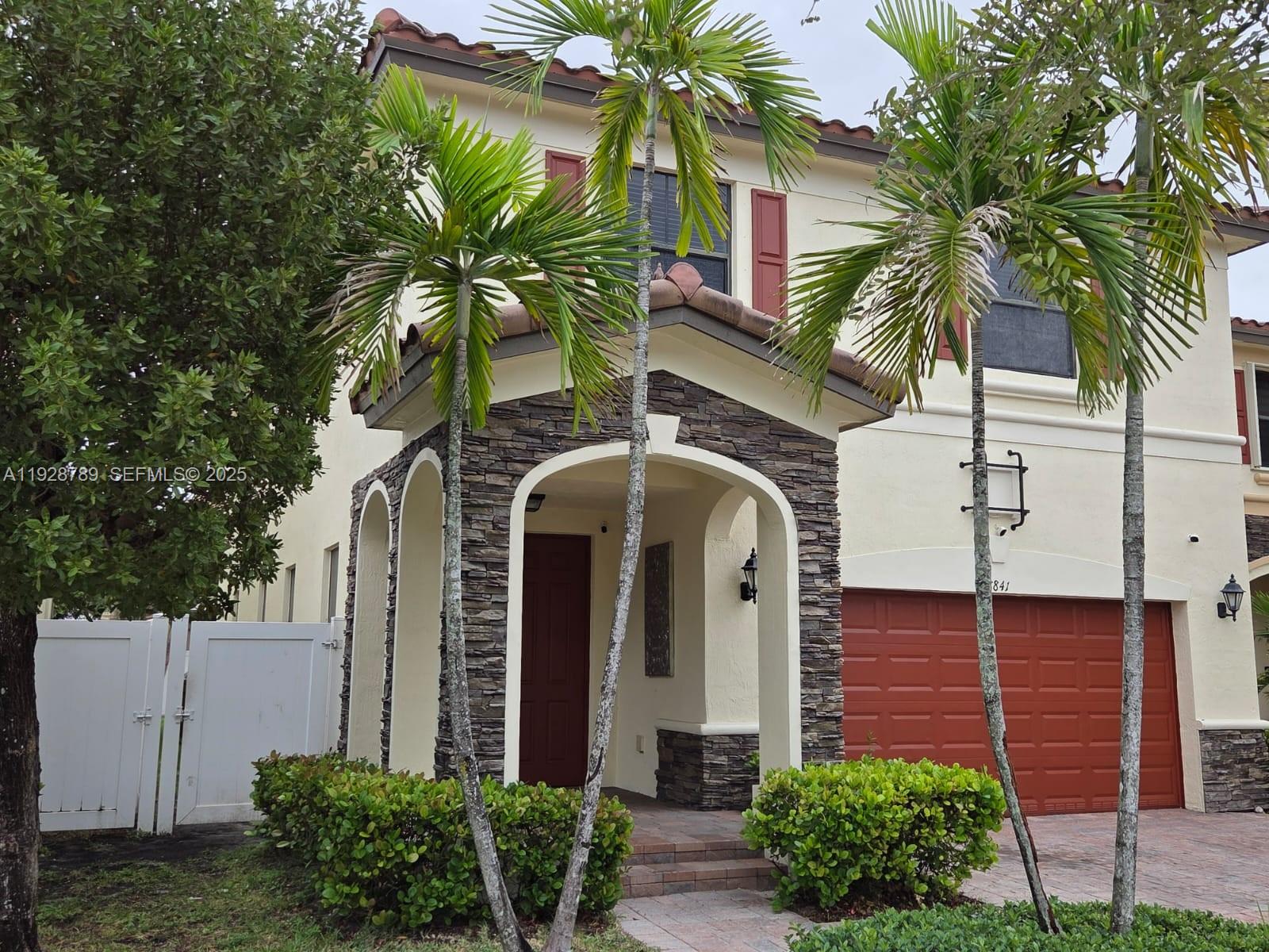 8841 West 34th Court Hialeah, FL 33018 - Photo 16 of 48 a front view of a house with a yard