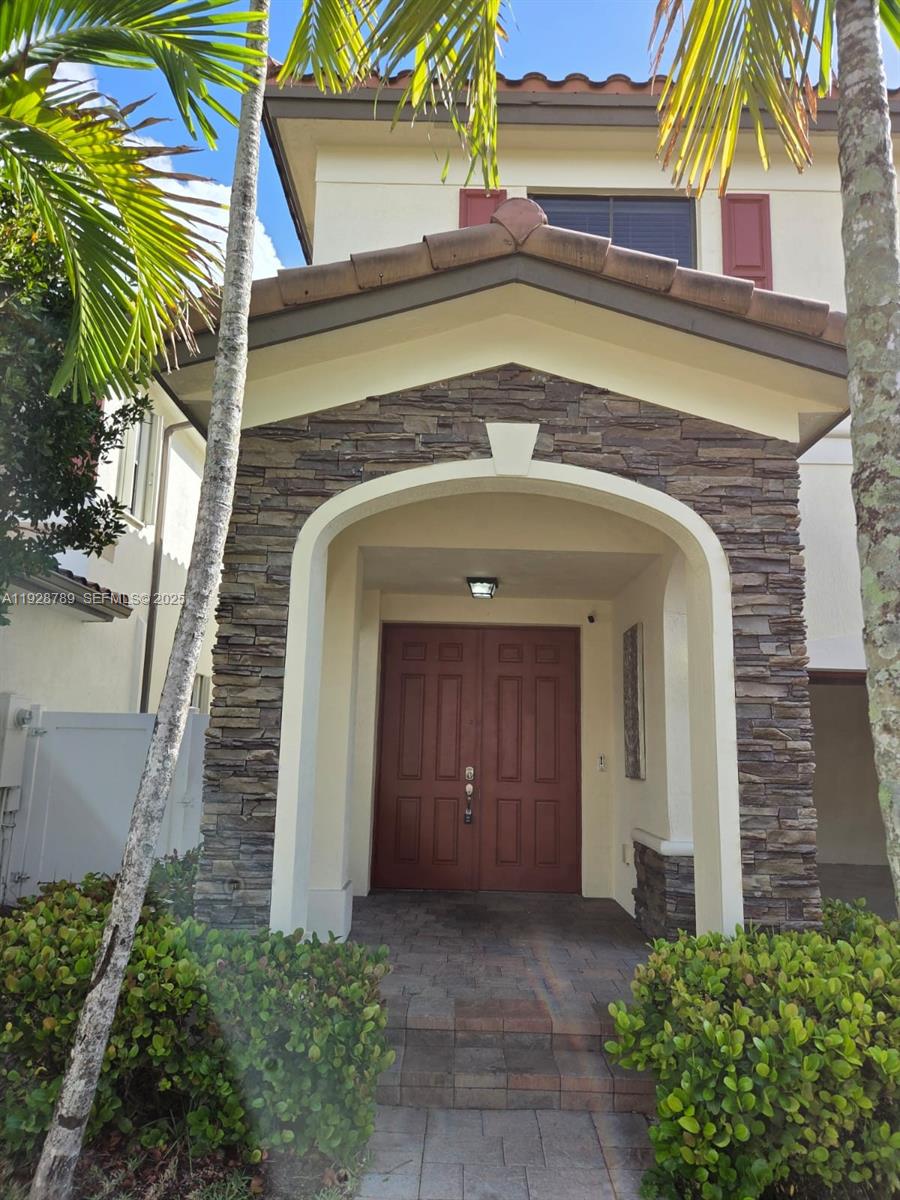 8841 West 34th Court Hialeah, FL 33018 - Photo 19 of 48 a view of front door and small plants