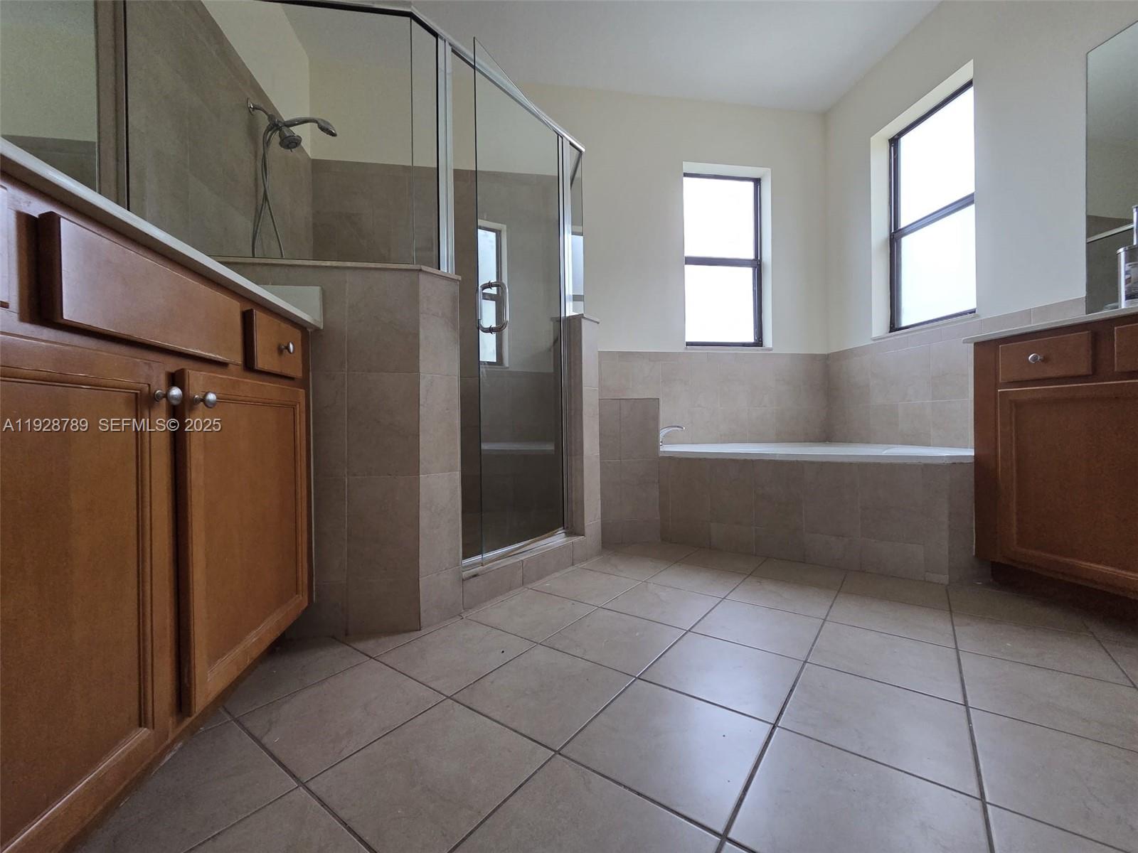8841 West 34th Court Hialeah, FL 33018 - Photo 23 of 48 a bathroom with a bathtub and shower