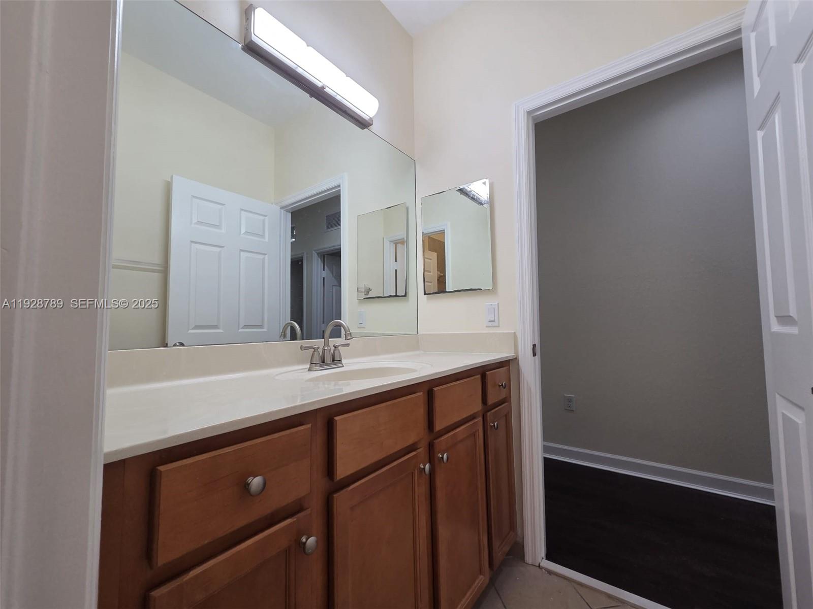 8841 West 34th Court Hialeah, FL 33018 - Photo 23 of 48 a bathroom with a sink and a mirror