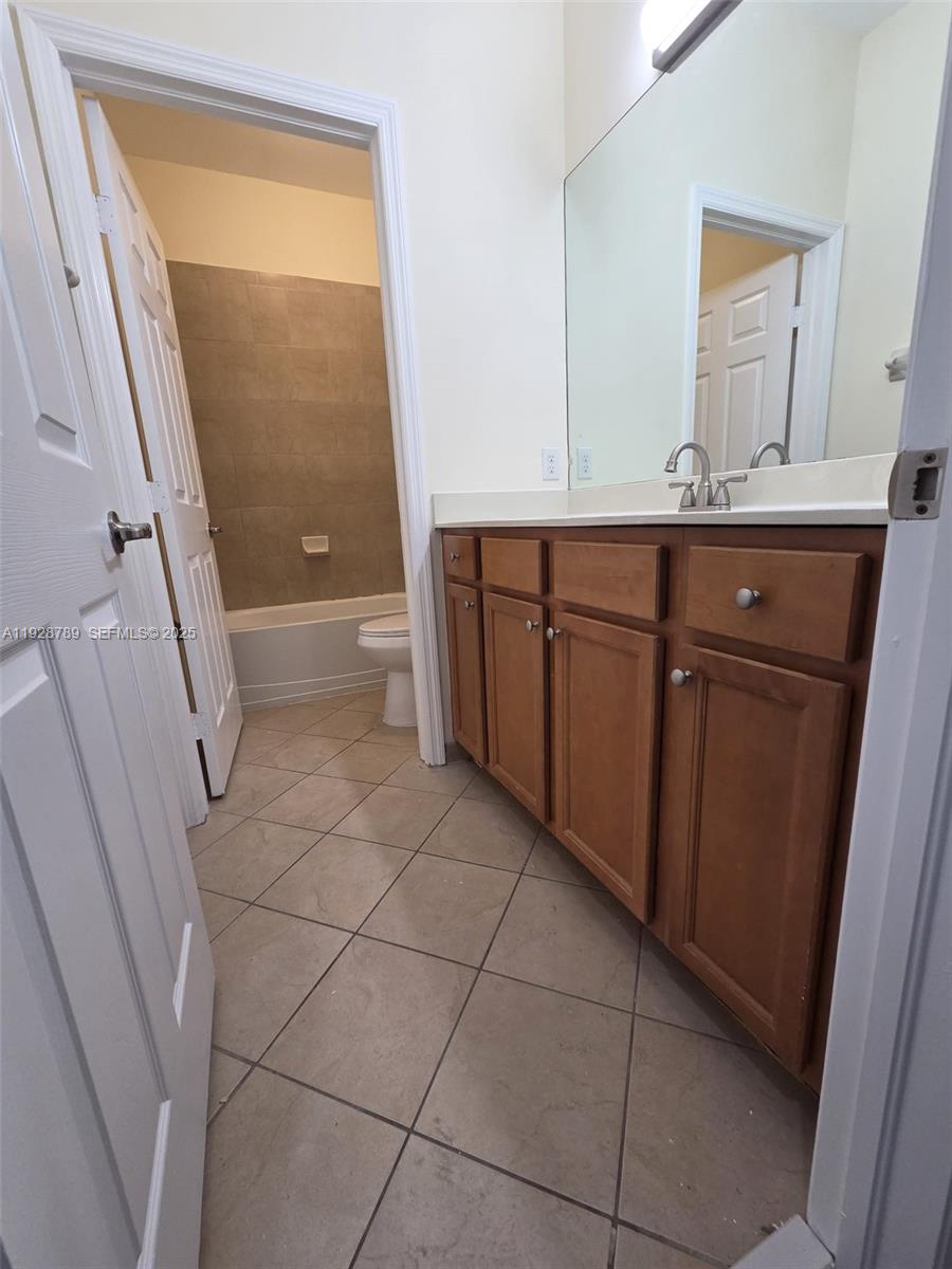8841 West 34th Court Hialeah, FL 33018 - Photo 25 of 48 a bathroom with a granite countertop sink and a mirror