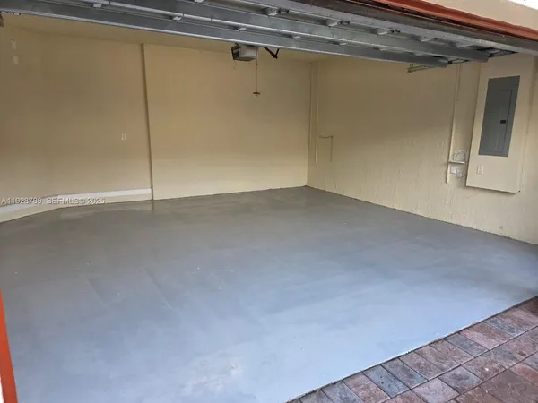 an empty room with wooden floor and windows in it