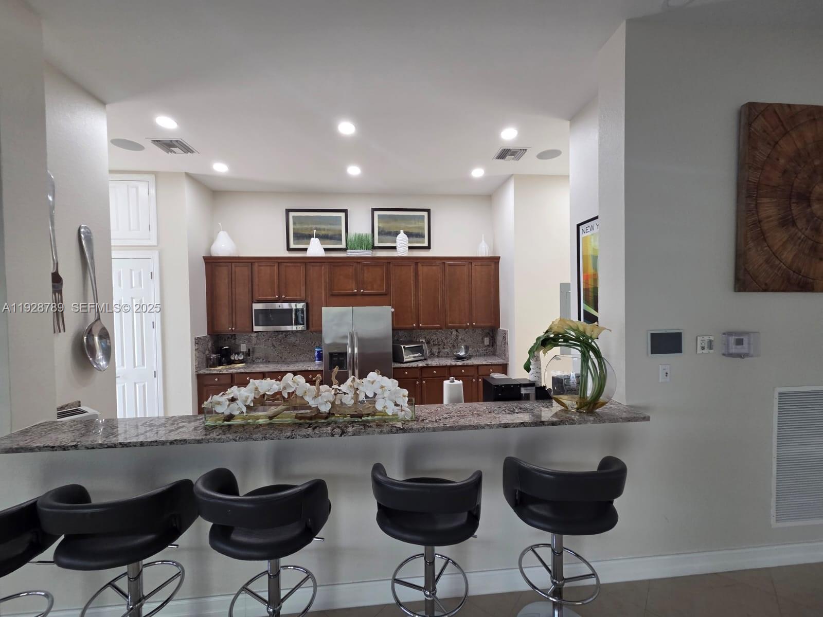 8841 West 34th Court Hialeah, FL 33018 - Photo 36 of 48 a kitchen with stainless steel appliances kitchen island granite countertop a sink and cabinets