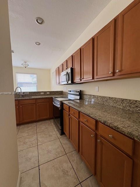 8841 West 34th Court Hialeah, FL 33018 - Photo 8 of 48 a kitchen with stainless steel appliances granite countertop a sink stove and refrigerator