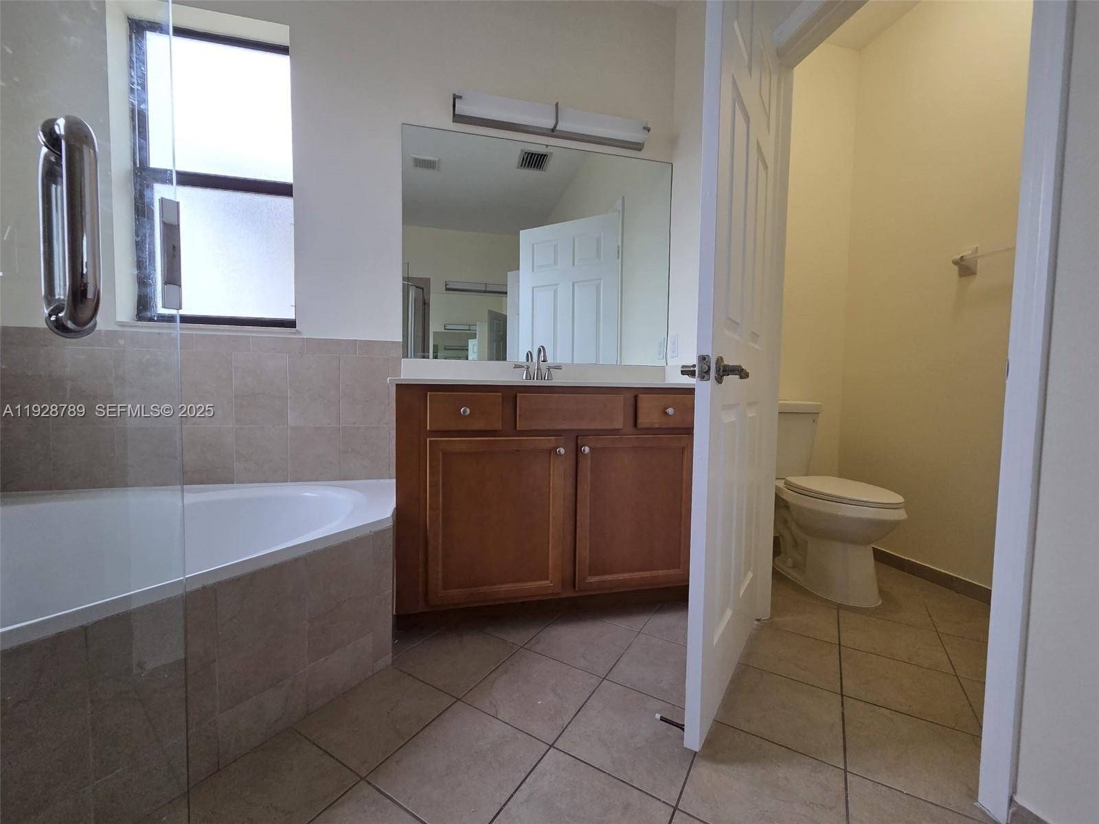 8841 West 34th Court Hialeah, FL 33018 - Photo 10 of 48 a bathroom with a sink a toilet and a bathtub