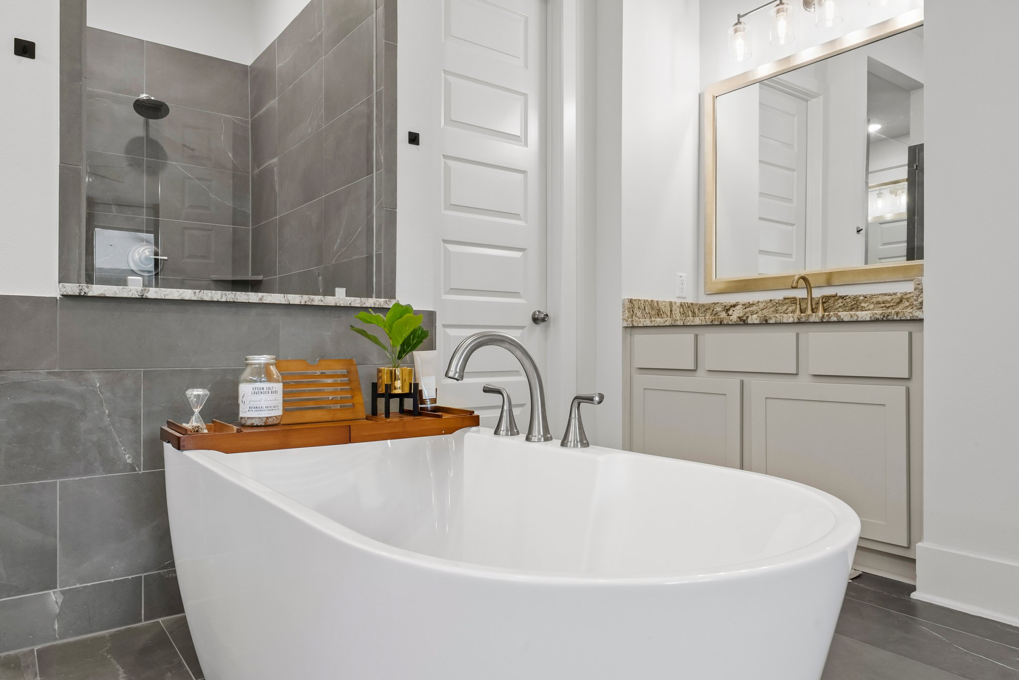 124 Low River Lane Georgetown, TX 78628 - Photo 18 of 38 a white bath tub sitting in a bathroom