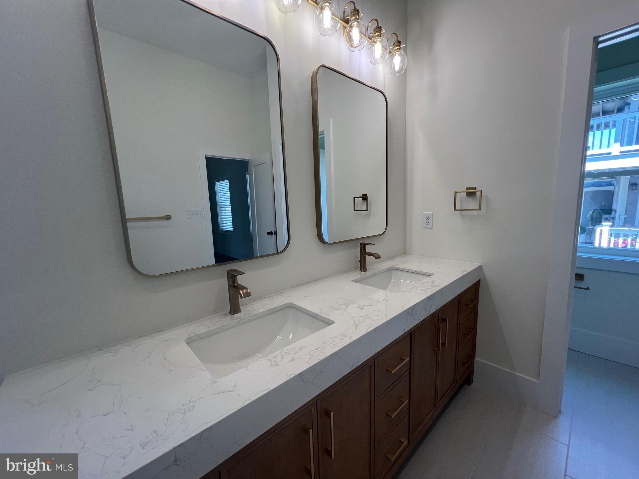 183 Ellicott Road Avondale, PA 19311 - Photo 16 of 92 a bathroom with double vanity sinks and a mirror