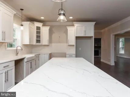 a spacious bathroom with a granite countertop sink mirror and toilet